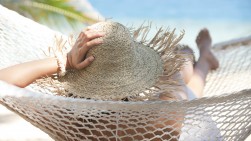 Woman relaxing in a hammock on a tropical beach Woman relaxing in a hammock on a tropical beach