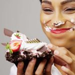 Frau isst Schokokuchen und ist glücklich